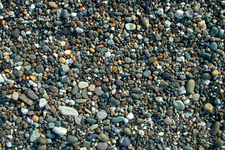 Multi colored stones on beach. Stones background for designの写真素材