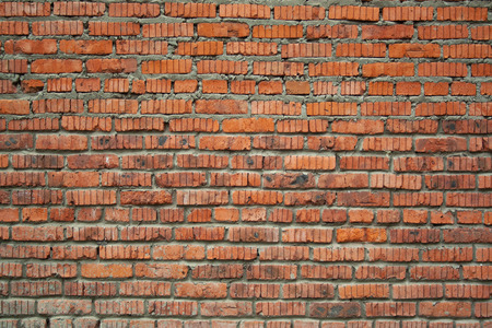 Red aged bricks texture. Old cracked and weathered bricks wall background. Texture for design and textの写真素材