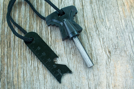 Flint and a brace tied with cord on a wooden backgroundの写真素材