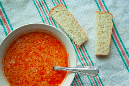 Soup with sour cream and bread in the background close-up on a towel. Delicious cabbage soup with a spoonの写真素材