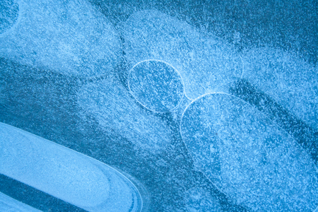 Pattern of frozen water with air bubbles. Frozen water textureの写真素材