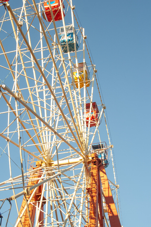 Ferris wheel at sunny warm day. Amusement park. Family recreation conceptの写真素材