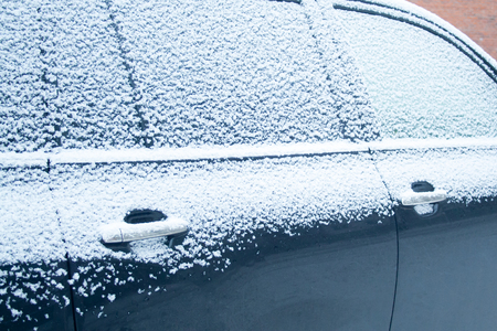 Snow covered car on cloudy snowy day. driving safety concept. Driving winterの写真素材