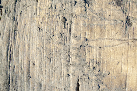 Stone texture close-up. Old aged stone surface on sun backgroundの写真素材