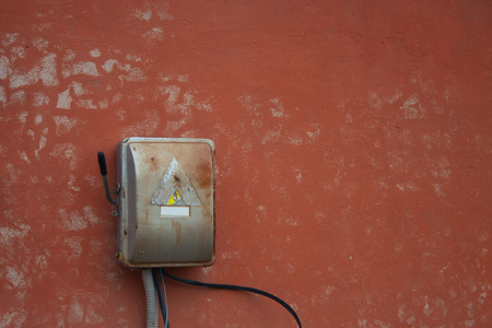 Old power box on red wall. Old electric boxの写真素材