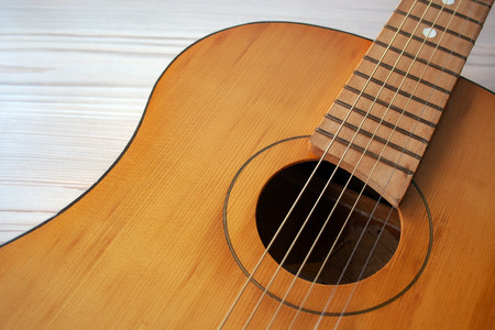 Classic Guitar close up on bright wood background. Music conceptの写真素材