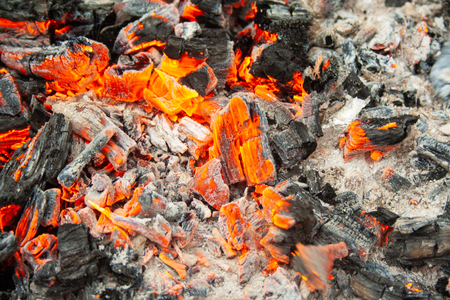 Fire, coals and ash close-up. Bonfire in the afternoonの写真素材