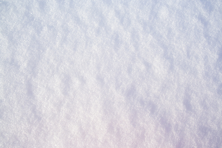 Snow surface background close up at sunny winter dayの写真素材