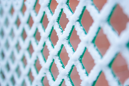 Plastic frost fence with crystals of snow pattern close upの写真素材