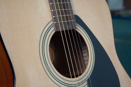 Close up of acoustic guitar with metal strings. Music concept. Hobby, leisure concept. Learn to play the guitar.の写真素材