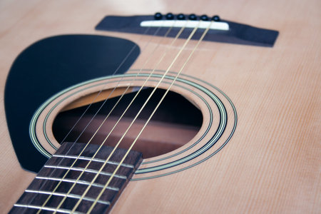 Close up of acoustic guitar with metal strings. Music concept. Hobby, leisure concept. Learn to play...