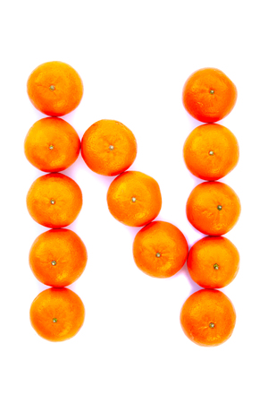 Letter solved with tangerines isolated on white background. Mandarine Â«NÂ» letterの写真素材