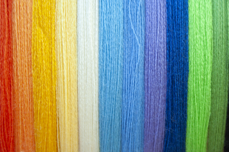 Many multi colored yarn strings for design background. Texture of colored thread. Concept of sewing, hobby image.の写真素材