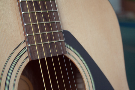 Close up of acoustic guitar with metal strings. Music concept. Hobby, leisure concept. Learn to play the guitar.の写真素材