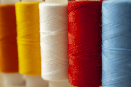Many multi colored yarn strings bobbins. Concept of sewing, hobby image.の写真素材