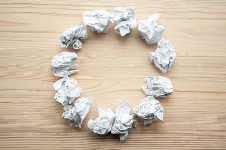 White crumpled paper balls folded on circle with copyspace inside. Design template with copyspace. Crumpled paper as brainstorming, creativity concept with place for textの写真素材
