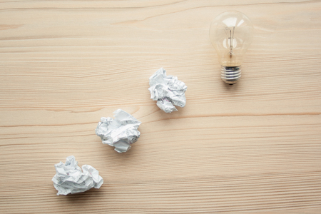 White crumpled paper balls folded in line with light bulb on the top. Concept of problem solution. Symbol of idea, innovation, inspiration, think different, think out of the box, leadership.の写真素材