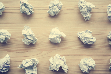 Many crumpled white paper balls from above background. Texture of crumpled paper balls.  Crumpled paper as brainstorming, creativity concept, mistakes and creation symbol. tonedの写真素材