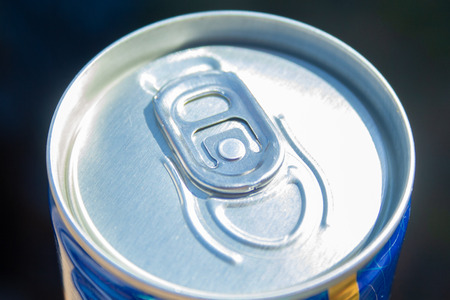 Can of beer close up at sunny day. Fresh drink at warm day. Metallic can with cold drink. Alcohol drink.の写真素材