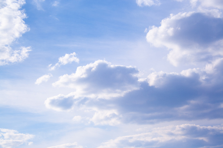 White clouds high in the sky at windy winter day backgroundの写真素材