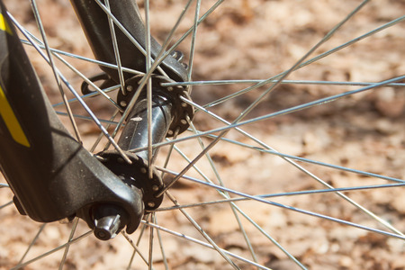 Dirty bike wheel with aluminium spokes at sunny day outdoors. Extreme sports and active vacation concept. Healthy hobbyの写真素材