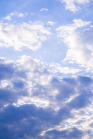 White clouds high in the sky at windy winter day backgroundの写真素材