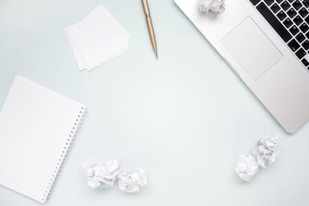 Work and creativity concept. Laptop, notepad, crumpled paper balls and pen top view flat lay photo with copyspace. Computer and paper work. Office aboveの写真素材