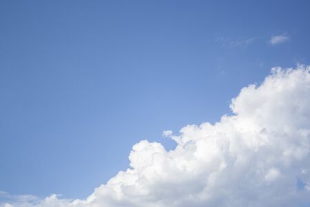 White clouds high in the sky at windy winter day backgroundの写真素材