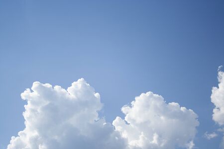 White clouds high in the sky at windy winter day backgroundの写真素材