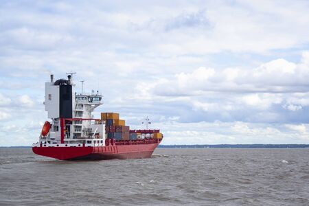 huge red barge with large containers on board. shipping cargo transportation by seaの写真素材