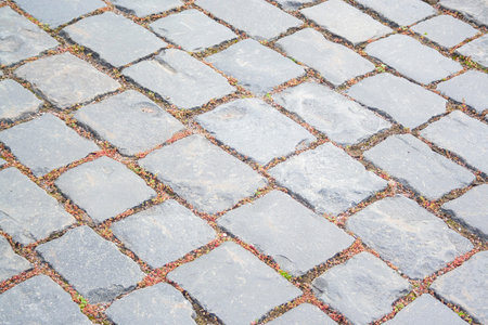Old aged granite paving stones. Texture of old granite paving stones. The texture of the pavement...