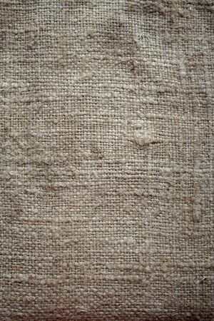 Aged vintage and weathered cloth background texture. Old damaged brown rough texture の写真素材