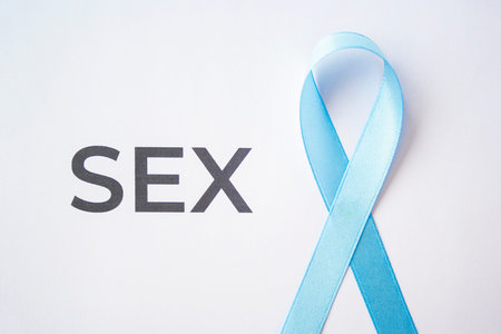 Blue ribbon as prostate cancer symbol on white paper with quote sex, quality of life with oncology,...