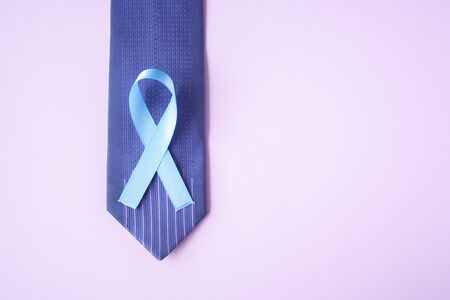 Prostate Cancer Awareness, light Blue Ribbon on blue men tie for support people living and illness. Men Healthcare and World cancer day concept. Men carcinoma health symbolの写真素材