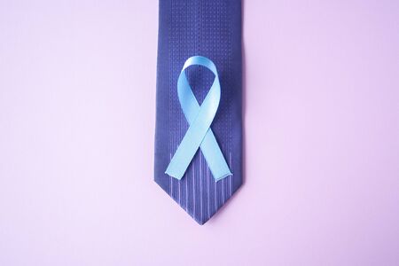 Prostate Cancer Awareness, light Blue Ribbon on blue men tie for support people living and illness. Men Healthcare and World cancer day concept. Men carcinoma health symbolの写真素材