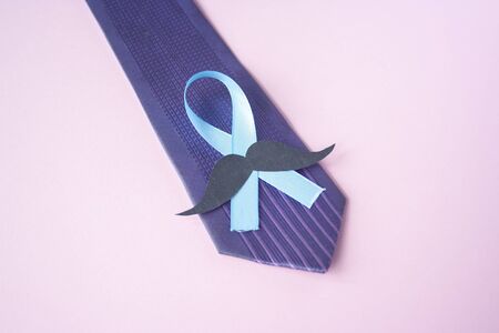 Prostate Cancer Awareness, light Blue Ribbon with mustache on blue men tie for support people living and illness. Men Healthcare and World cancer day concept. Men carcinoma health symbolの写真素材