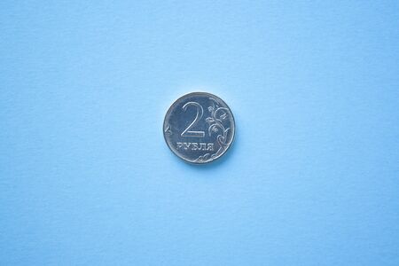 Coin two rouble on bright blue background. ruble depreciation. Rouble to dollarの写真素材