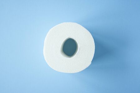 Toilet paper roll on a blue background top view. Toilet paper purchase due to kronavirus concept. Personal hygiene and stopping the spread of the virus. Cleanliness, Hygiene, Sterilityの写真素材