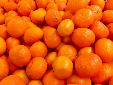 Fresh tangerines on a market stall. Fresh mandarin oranges fruit or tangerines as backgroundの写真素材