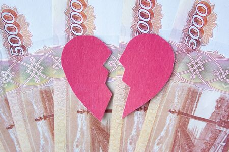Valentine heart broken in two on roubles banknotes. Love cannot be forced. Marriage of convenience. Love money more than people.

の写真素材