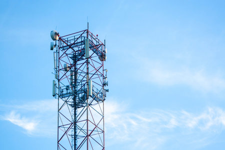 transmission tower built high under the blue