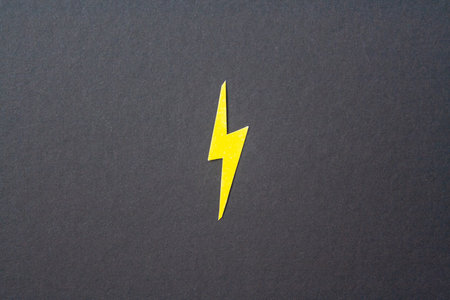 Yellow cut out lighting on black background. Idea conceptの写真素材