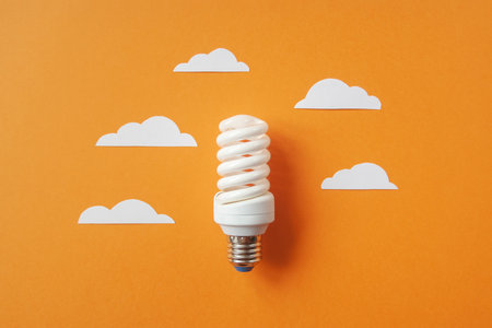 Light bulb with white cut out clouds. Idea conceptの写真素材