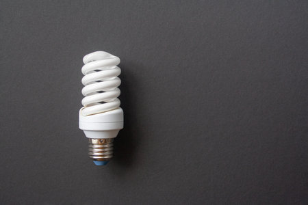 Energy saving light bulb on a black backgroundの写真素材