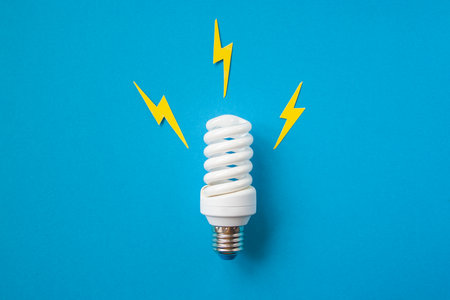 Light bulb with energy lightings on blue backgroundの写真素材