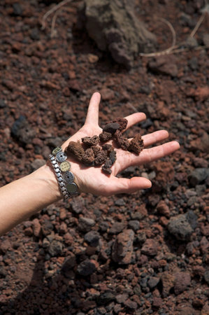 woman hand with volcanic stonesの写真素材