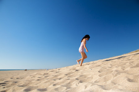 woman with violet dress at el palmar beach in cadiz spainの写真素材