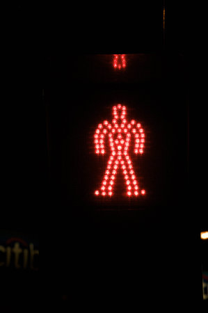 red man illuminated in a traffic lightの写真素材