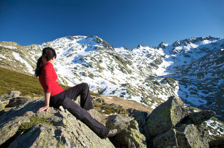 woman at the top of gredos mountains in avila spainの写真素材