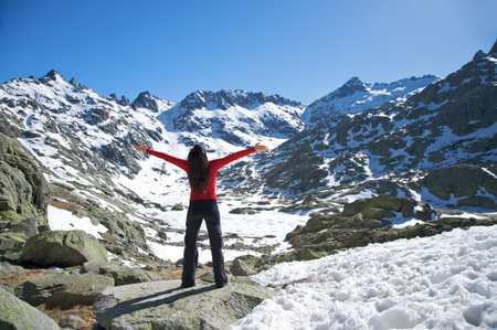 woman at the top of gredos mountains in avila spainの写真素材